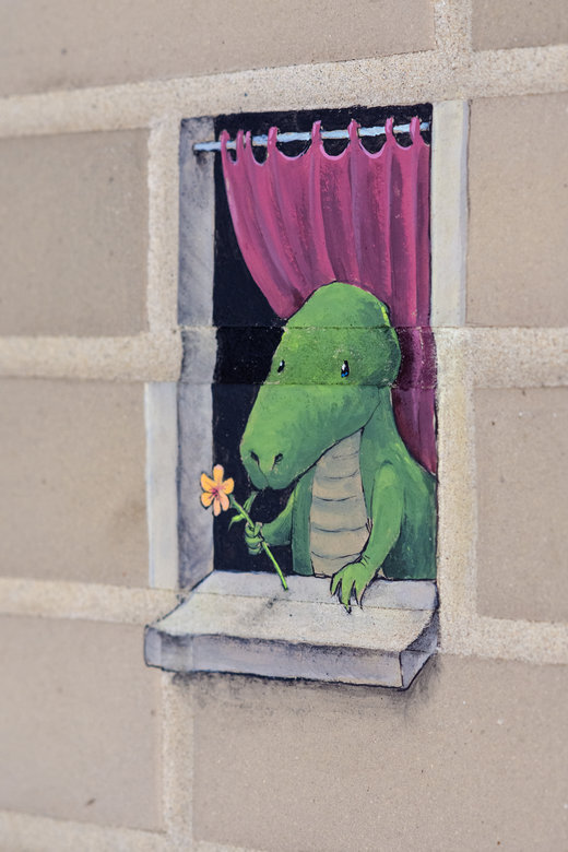 Cartoon dinosaur holding flower at window