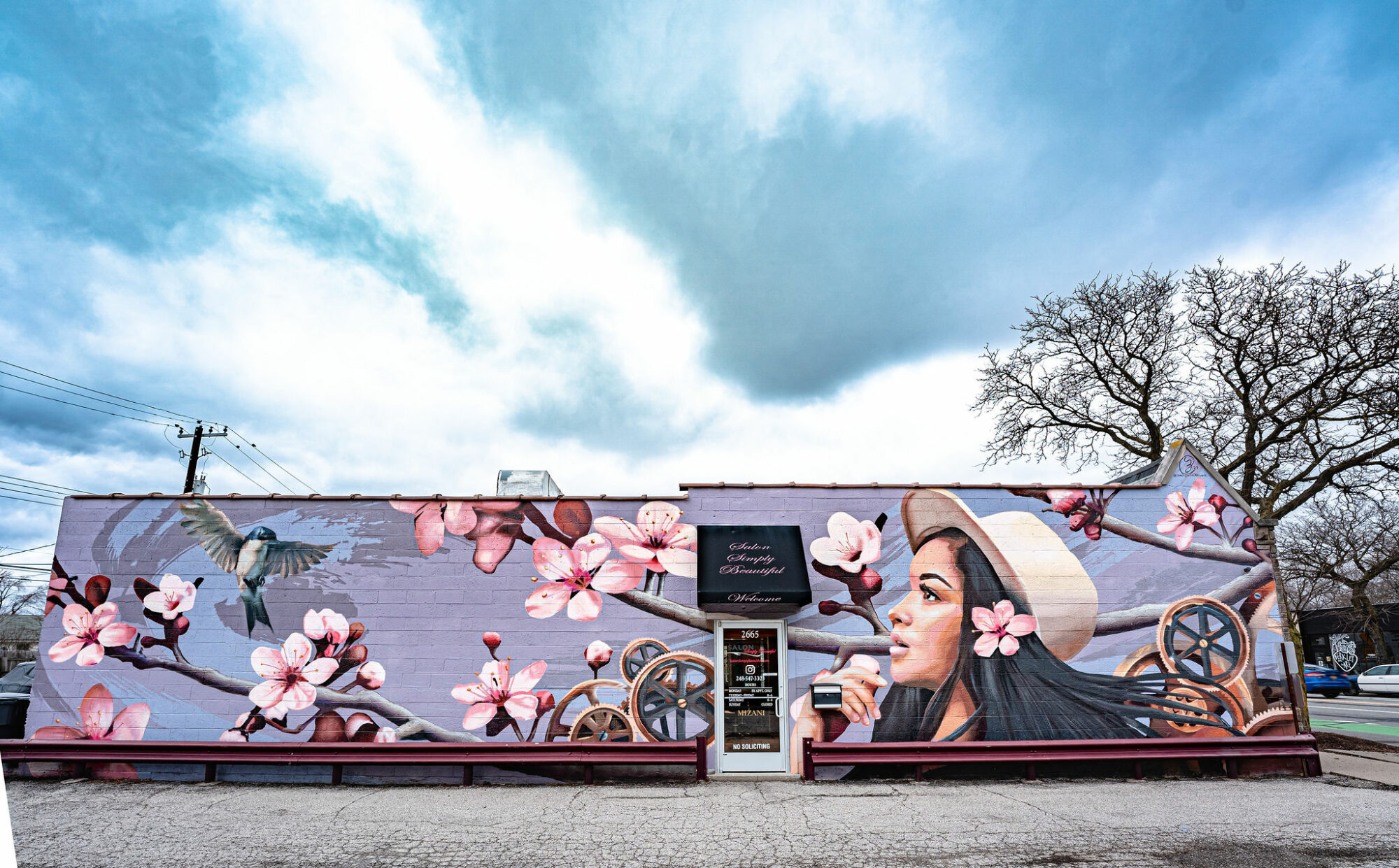 Colorful mural with flowers and a woman in hat.