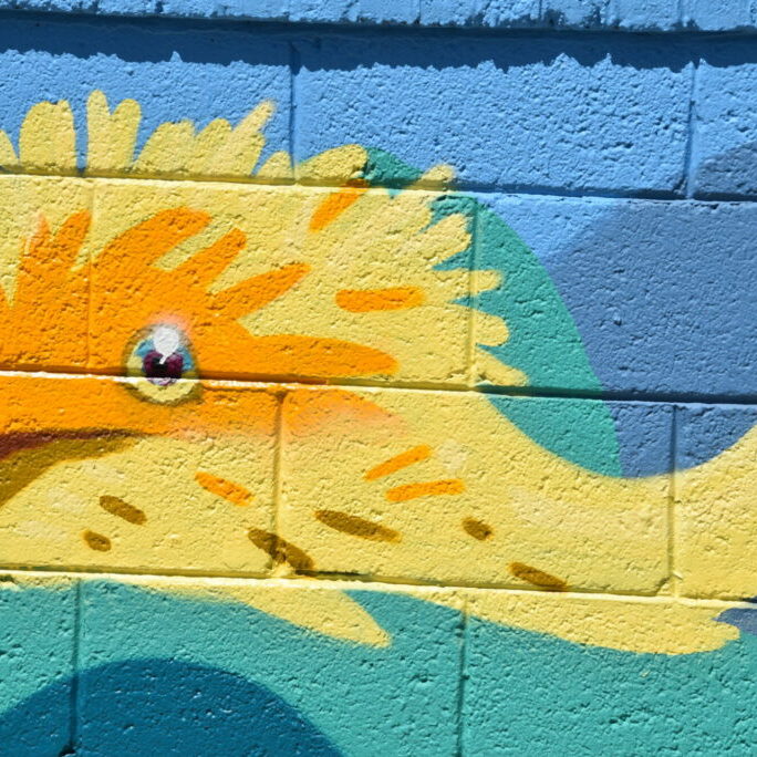 Colorful wall mural of yellow dragon.