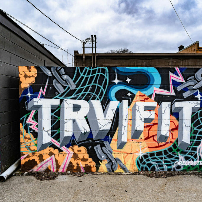 Colorful graffiti mural on urban building wall.