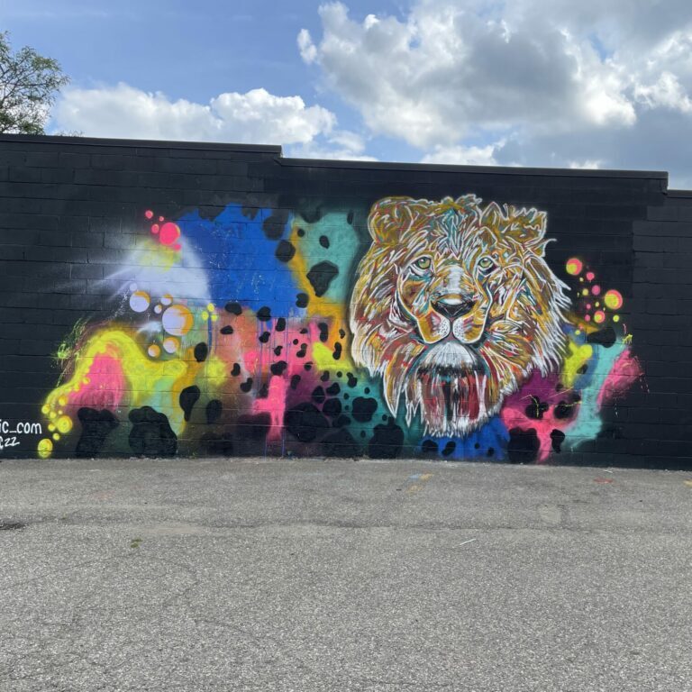 Colorful lion mural on a brick wall